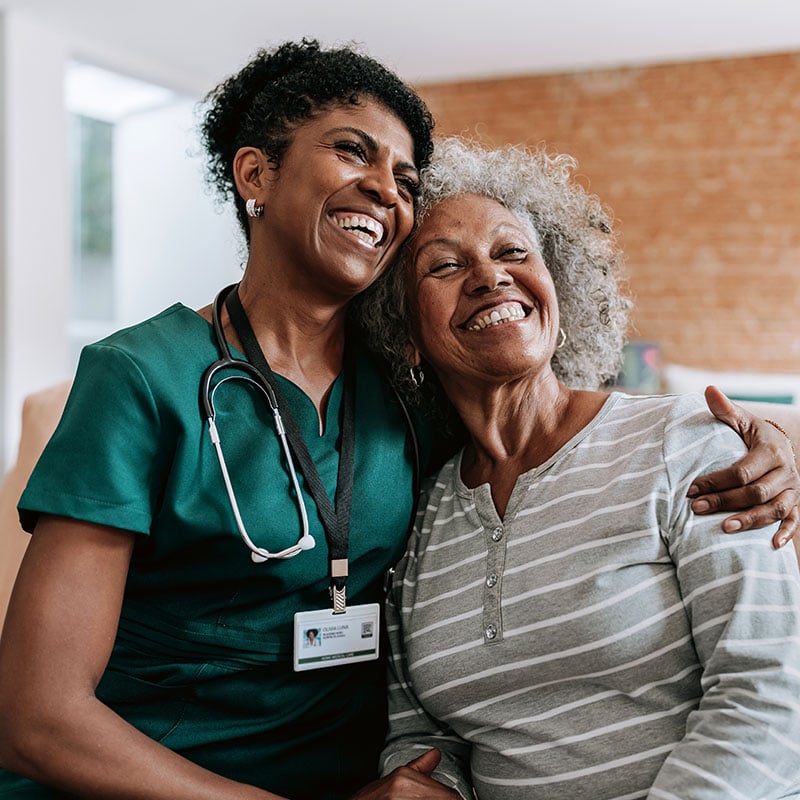 home care healthcare professional hugging elderly patient