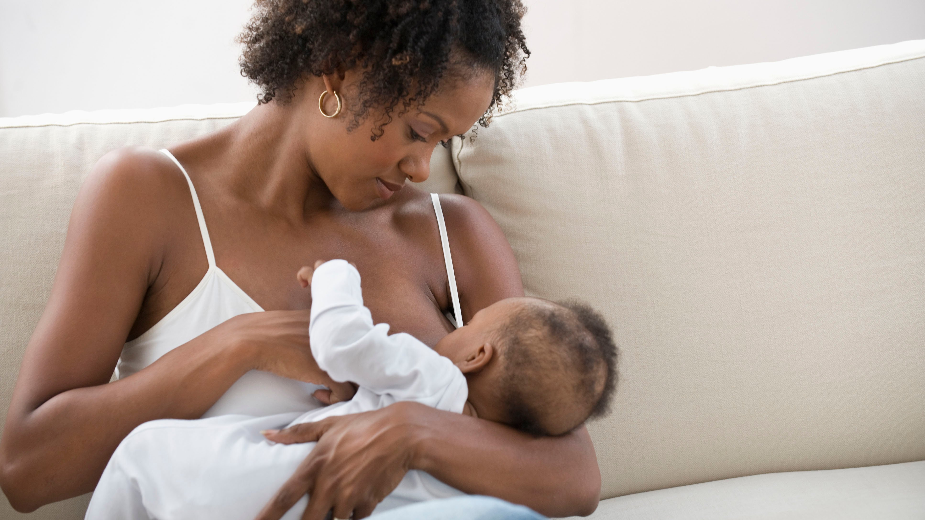 Breastfeeding_promo Mother breastfeeding her baby on a comfortable couch
