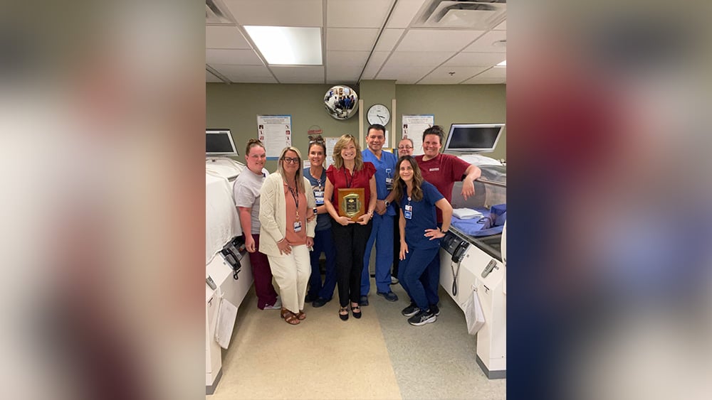 Group of wound care healthcare professionals smiling in medical setting