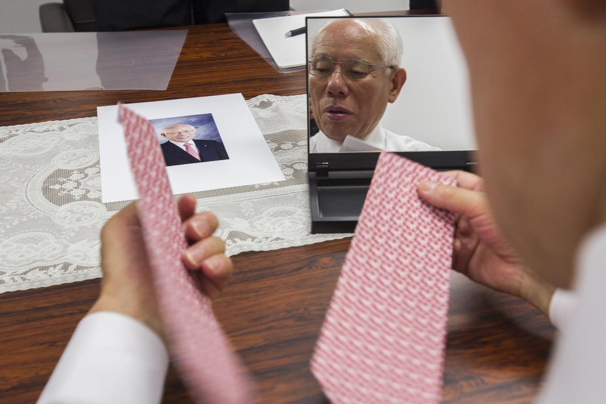 Sakuji Tanaka, 2012-13 Rotary International president, and his wife, Kyoko, select patterns and fabrics for his theme tie and scarf. The white flowers represent the iconic cherry blossoms of Japan.