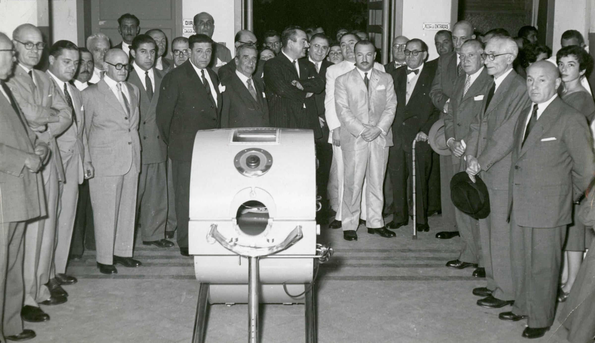 Members of the Rotary Club of Chivilcoy, Argentina, donate an iron lung, used to treat polio patients who can’t breathe on their own, to a local hospital. Circa 1956.