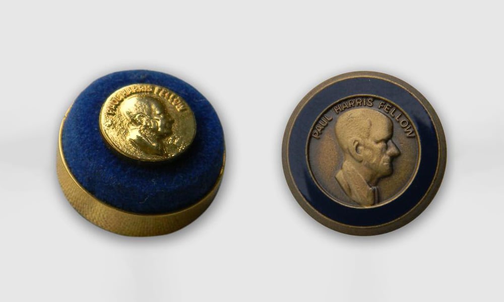 Left: The first men’s lapel pin. Right: The second men’s lapel pin.