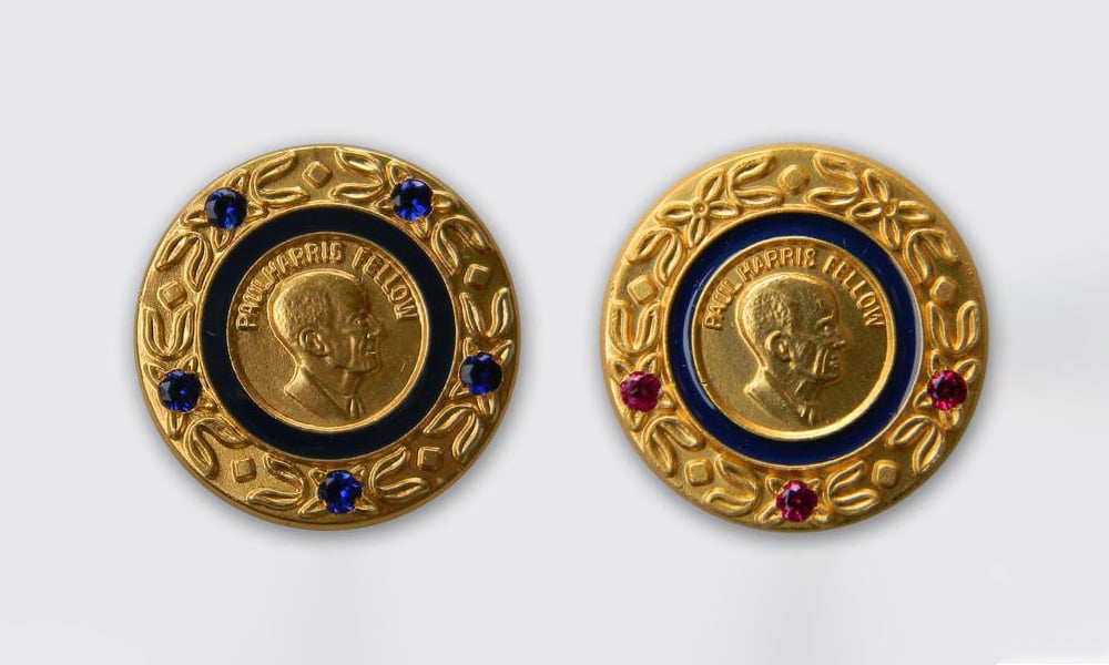 Left: Introduced in 1984, the blue-stone Multiple Paul Harris Fellow pin recognizes additional donations up to $6,000. Right: Red-stone Multiple Paul Harris Fellow pins were introduced in 1988 to bridge the gap between the blue five-stone pin and Major Donor recognition levels.