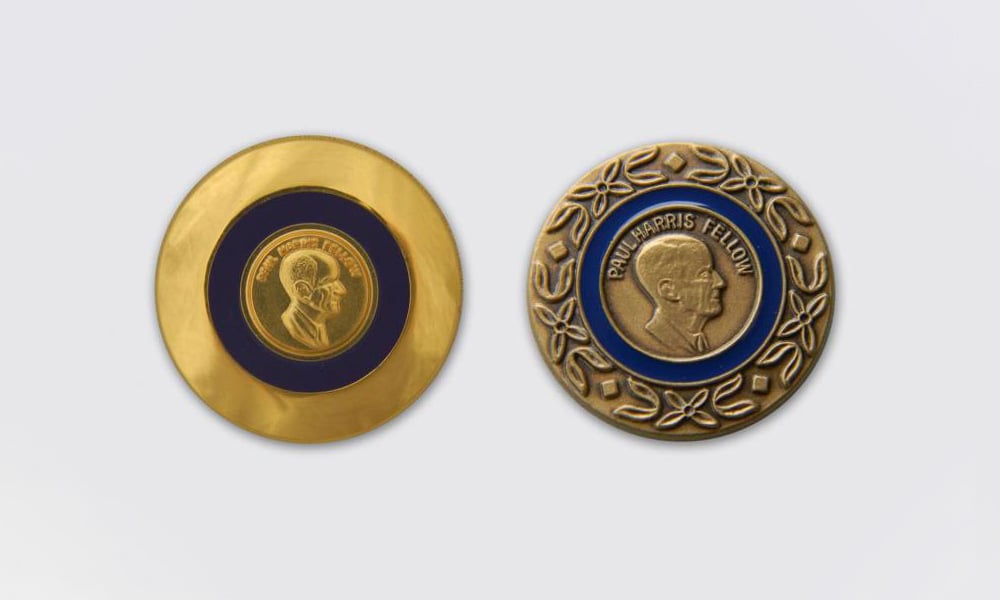 Women’s lapel pin, left, was used until 1997. In 1997, the Foundation standardized the designs of the medallion and lapel pin, using the same for men and women, right. Both bear the laurel wreath design of the Multiple Paul Harris Fellow pins and are still in use today.