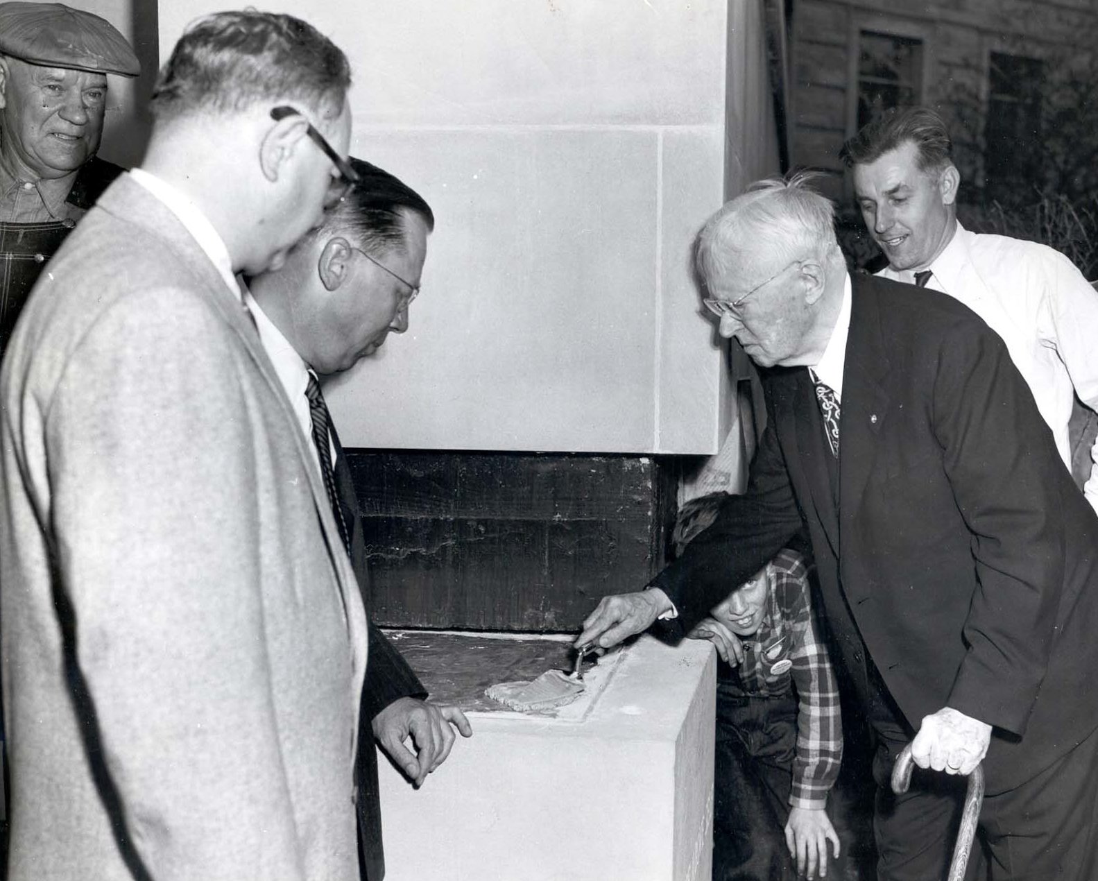 Guy Gundaker (with trowel), 1923-24 RI president, prepares to lay the cornerstone of the Ridge Avenue building in Evanston, Illinois, USA. 1954.