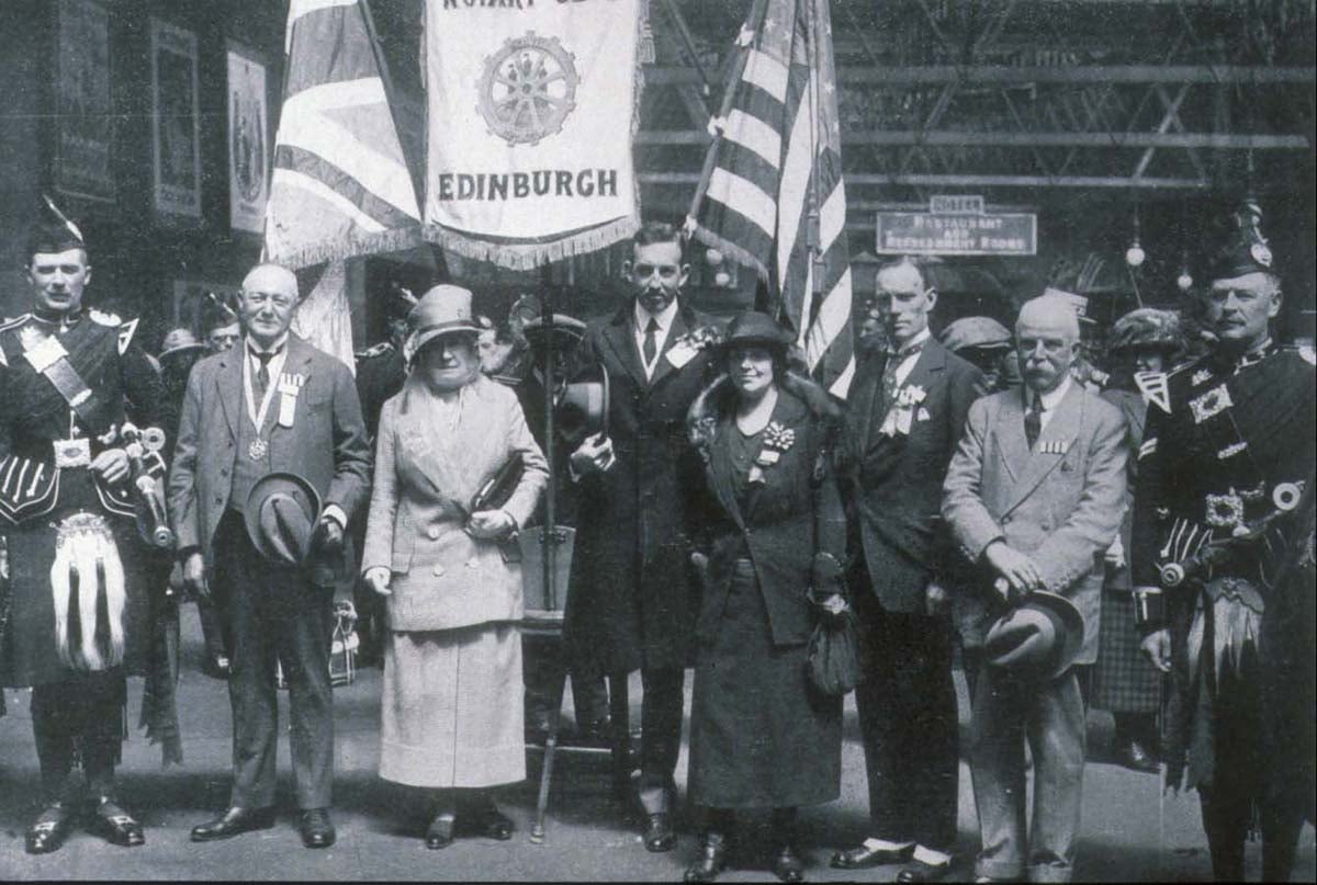 1920-21 Rotary President Estes Snedecor (center) and others pose with a Rotary Club of Edinburgh, Scotland, banner at the 1921 Rotary Convention in that city, the first to be held outside of the United States.