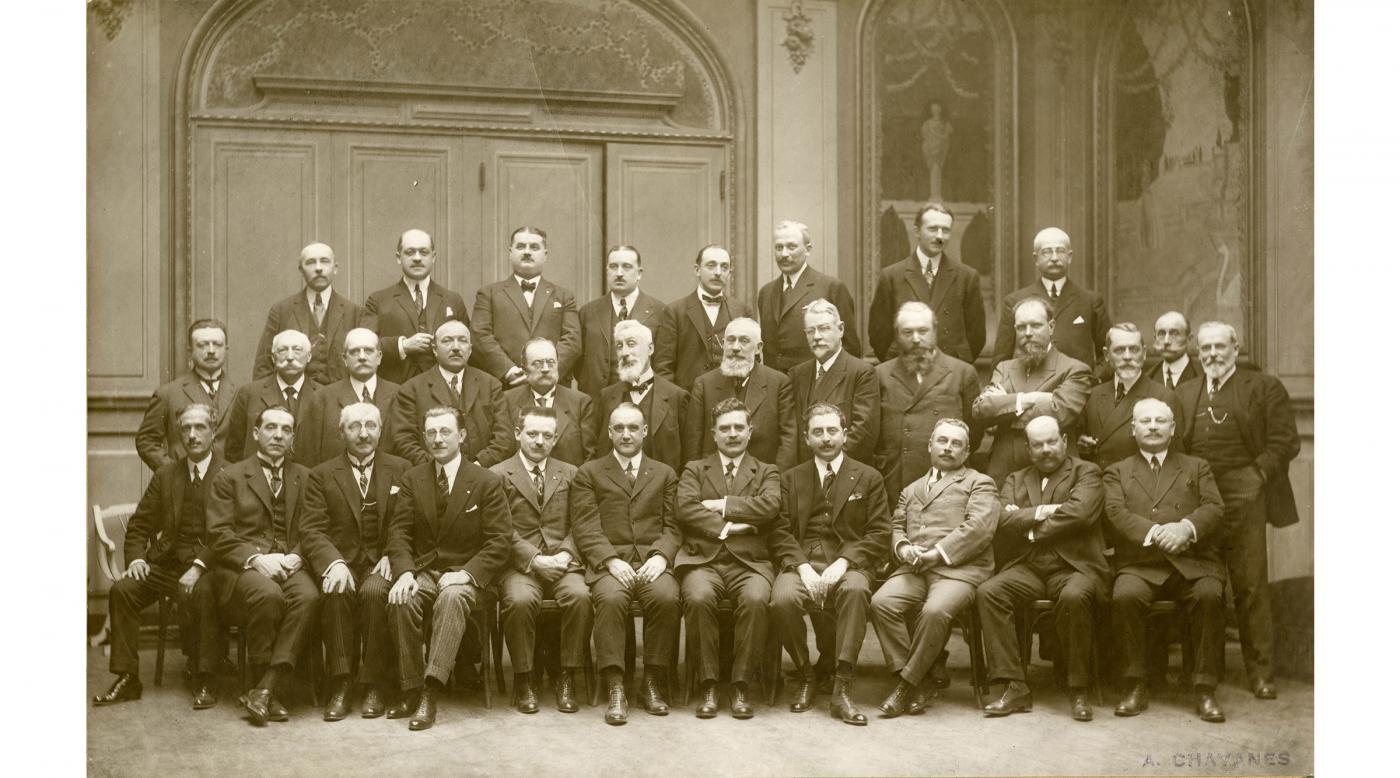 An early meeting of the Rotary Club of Lyon, France, which received its charter in October 1923. Club founder Etienne Fougère is in the center of the first row, with his arms folded. The meeting was attended by members of the Rotary Clubs of Barcelona, Spain, and Paris, France.