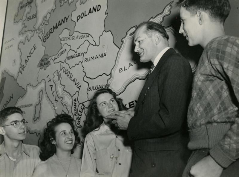 Chester Williams speaks to high school students during an Institute for International Understanding event in Sturgis, Michigan, USA. Appeared in "The Rotarian" February 1944.