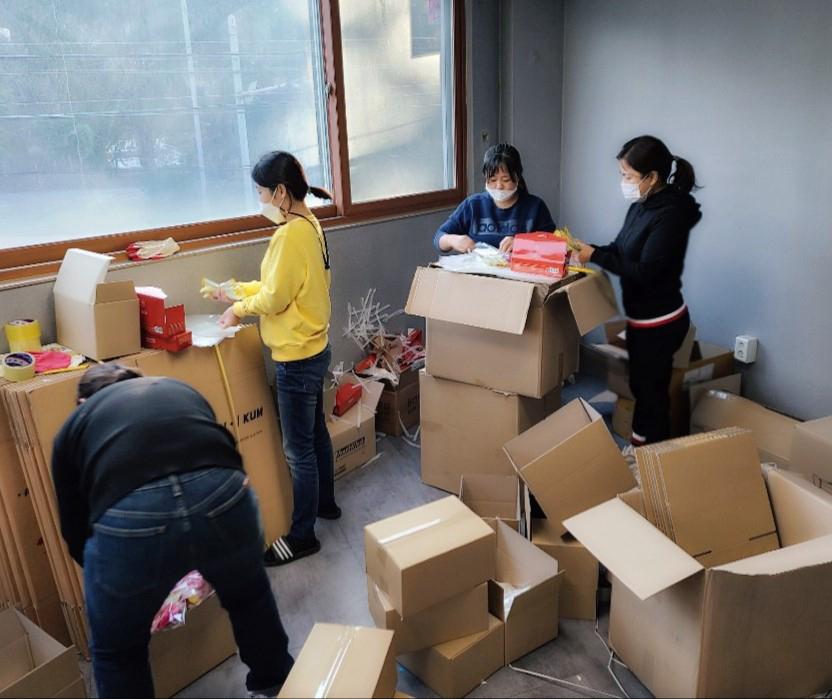 Members of the Rotary Club of Ulsan Freedom, South Korea, work on a COVID-19 kit distribution project. The club was charted in 2016 and helps refugees acclimate to South Korean society.