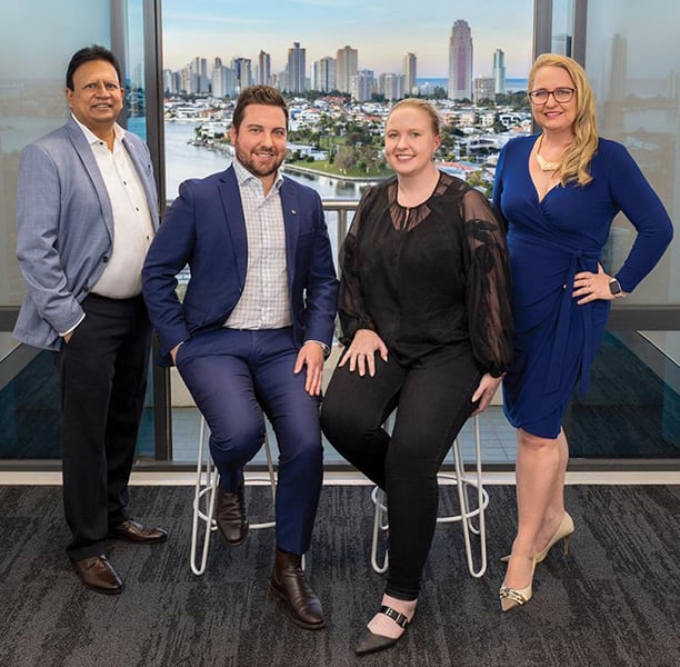 Andy Rajapakse, who helped start the Rotary Club of Gold Coast Corporate, with club members Derek Finch, Laura Johnstone, and Anna Morgan