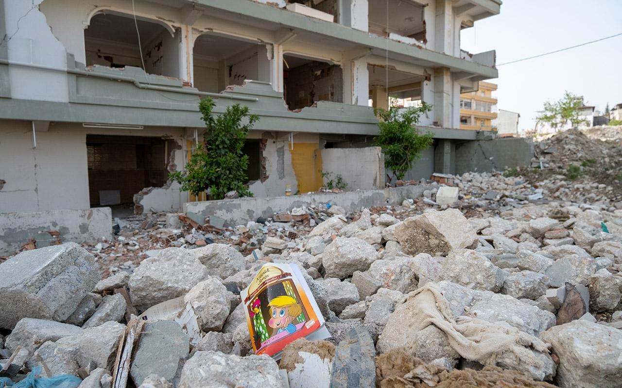 Damaged building in Turkey surrounded by rubble, with a children's book visible among the debris.