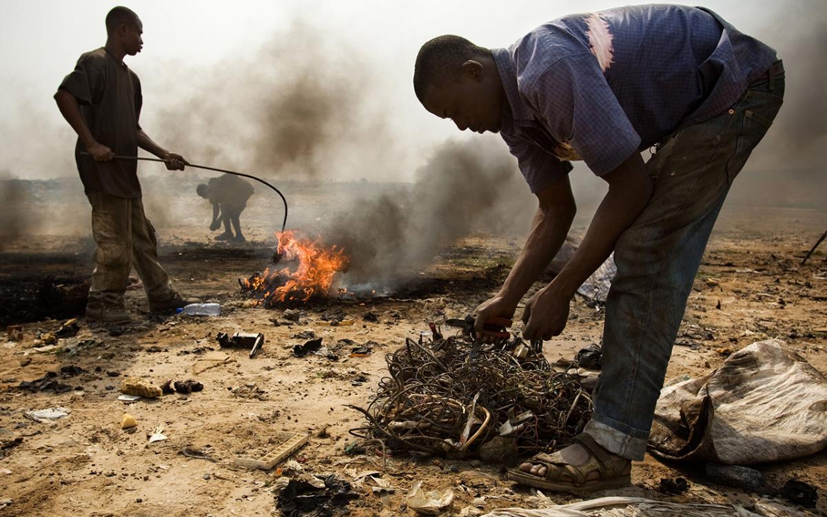 In Ghana, teenagers burn cables from computers and other electronic devices to recover valuable copper