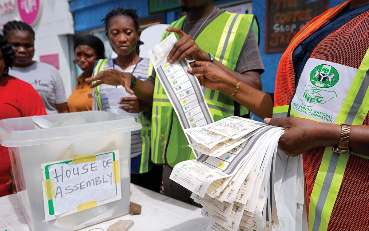 Officials count ballots in front of party agents and observers at a polling station in Lagos during Nigeria’s gubernatorial and state assembly election.