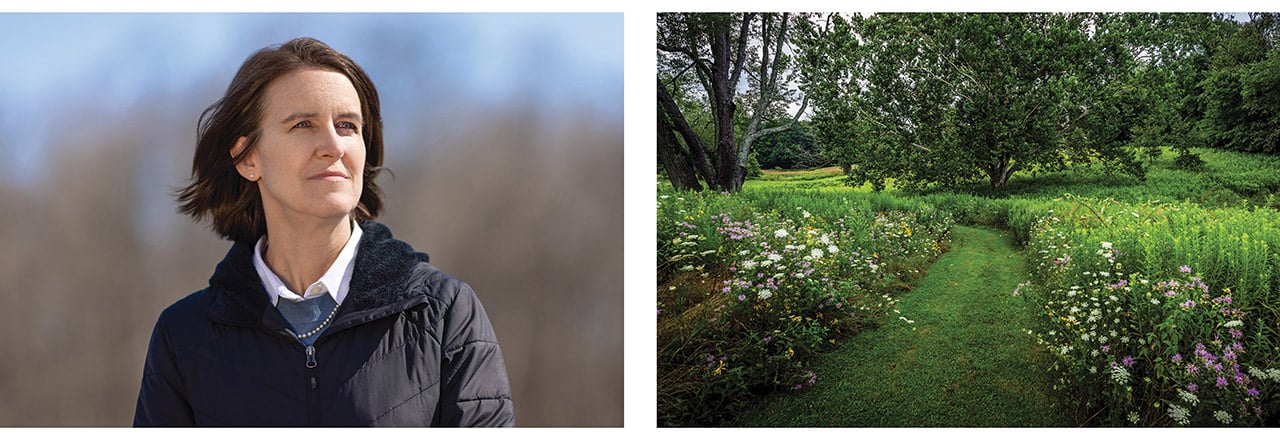 Rotarian Amy Henricksen standing outdoors beside a garden path lined with flowering plants.