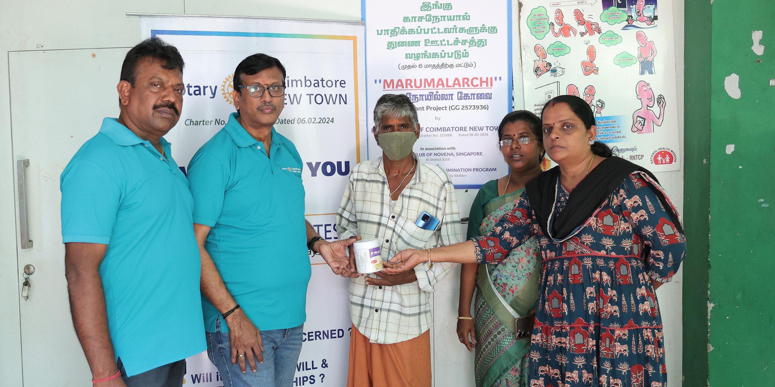 Members of the Rotary Club of Coimbatore New Town display the nutritional supplement.