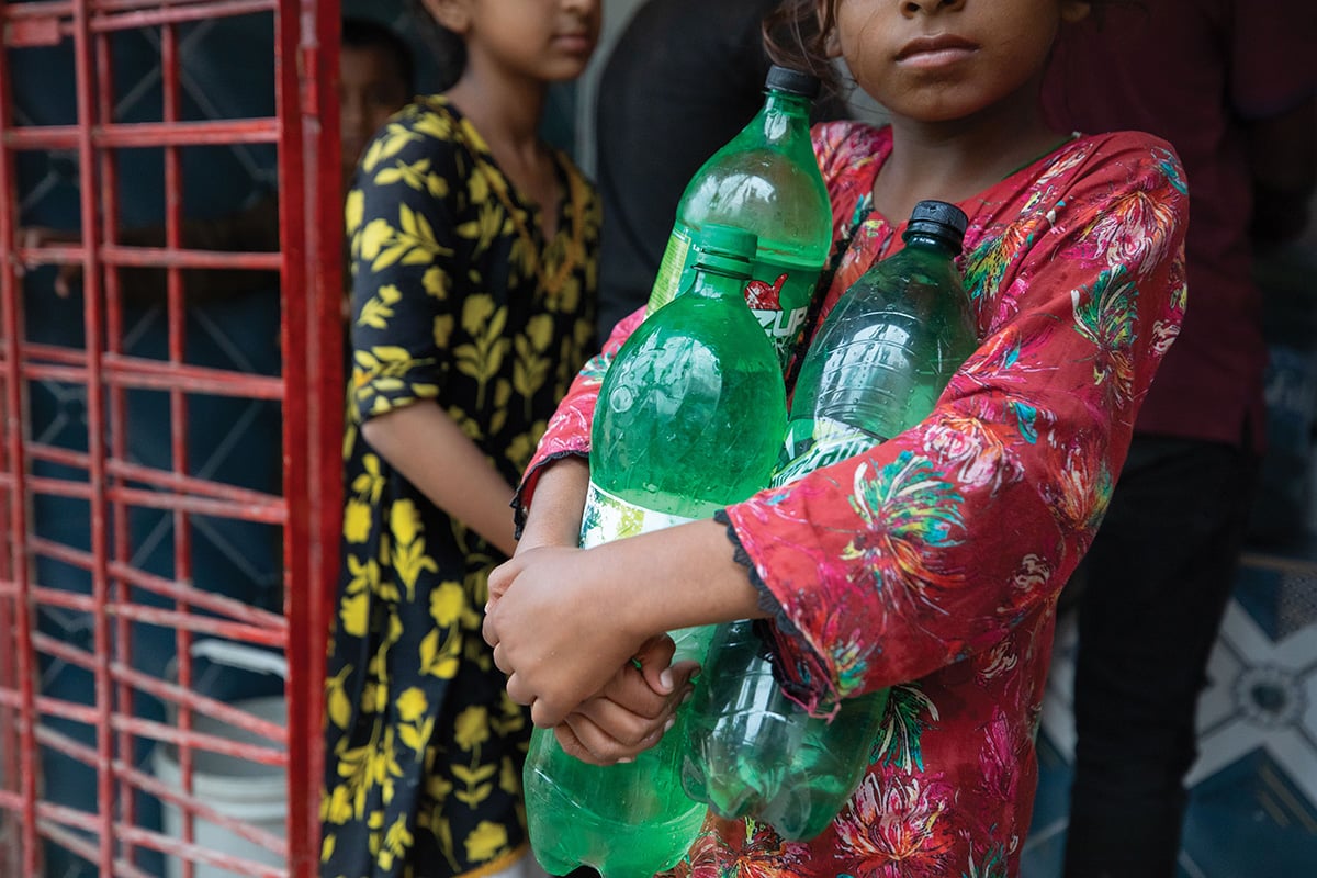 Girl holding bottles of drinking water