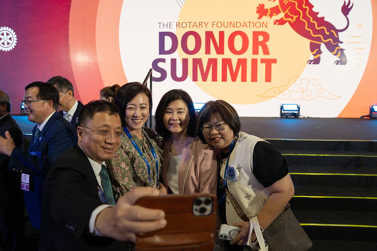 People pose for a photo in front of a sign for The Rotary Foundation Donor Summit in Taipei, Taiwan, 15 June 2026.