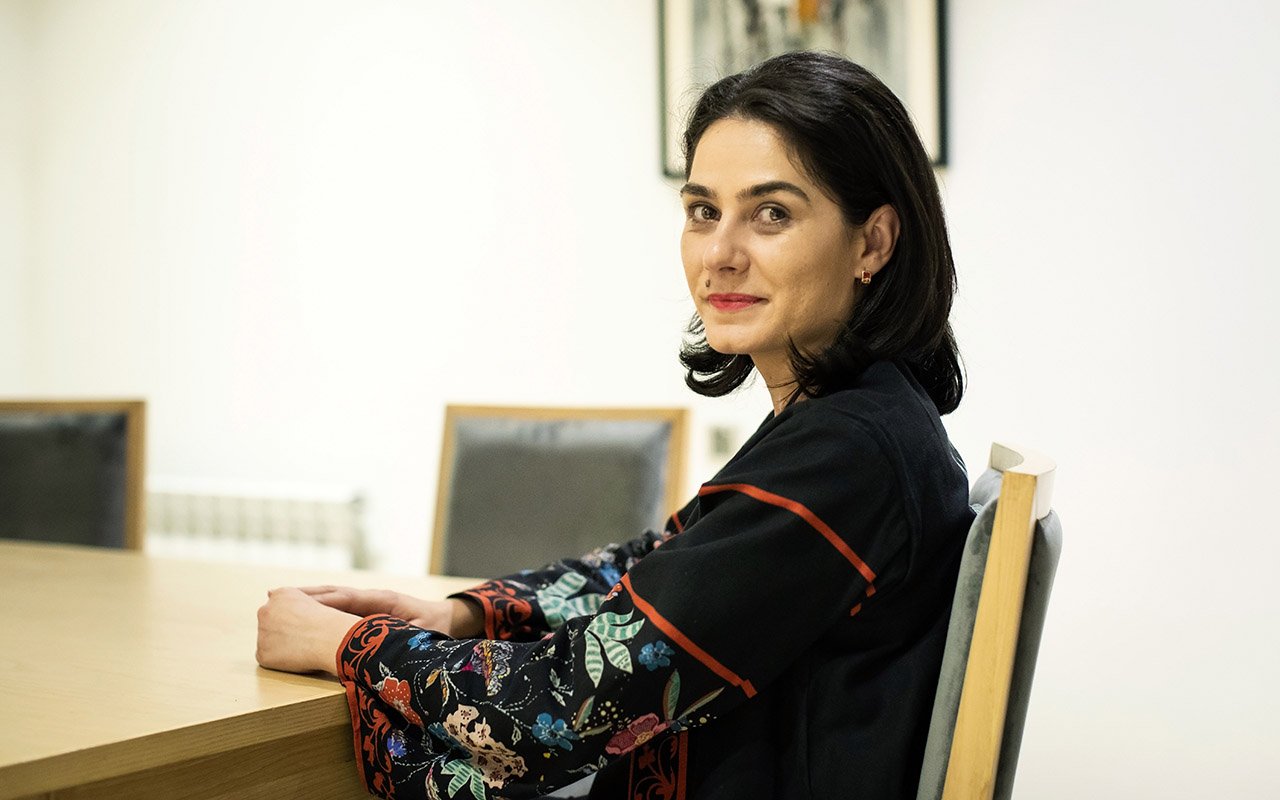 Diana Maria Pirga, Rotary Club of Türkiye Evrensel, District 2430 sits at a table.