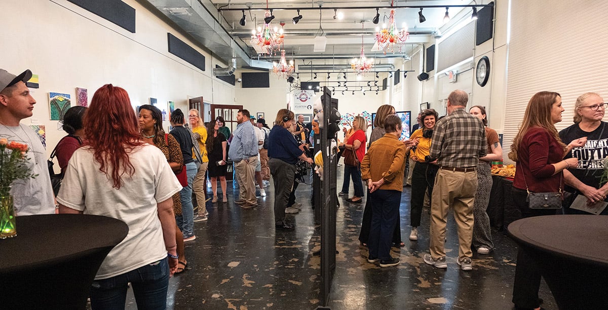 People attending the Healing in Color: Stories of Strength & Hope exhibit