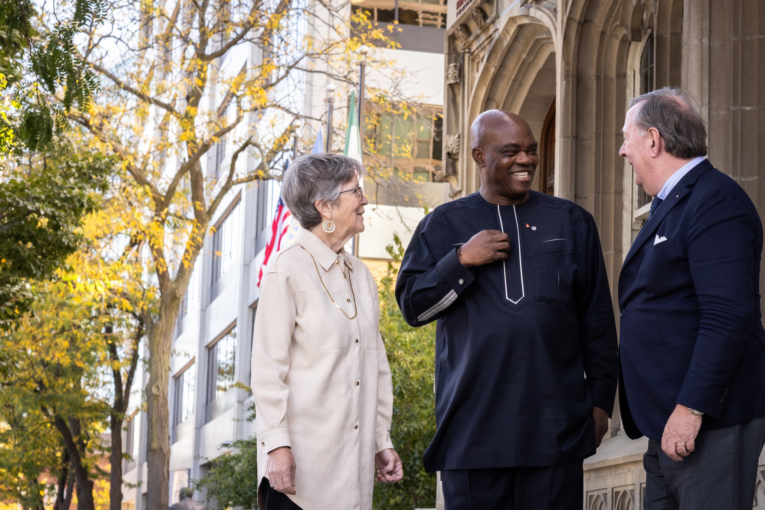 President-elect Olayinka Hakeem Babalola stands outside Rotary’s headquarters building with Rotary Foundation Trustee Martha Peak Helman and RI Vice President Alain Van de Poel.
