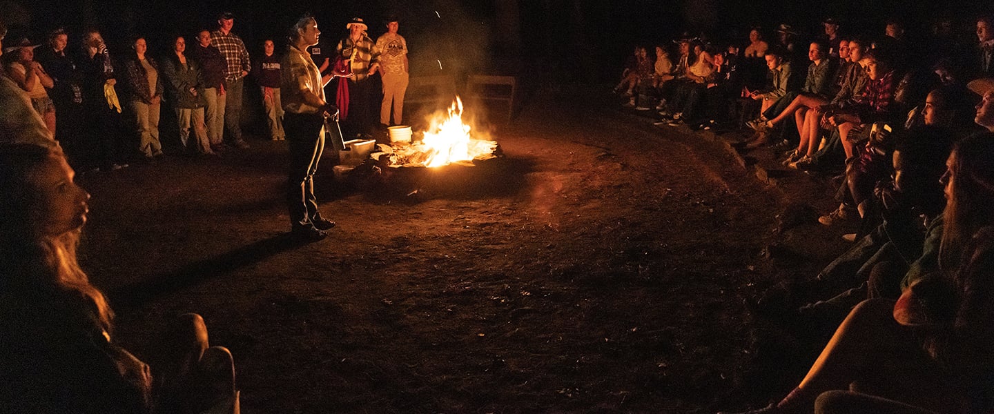 People surrounding a campfire