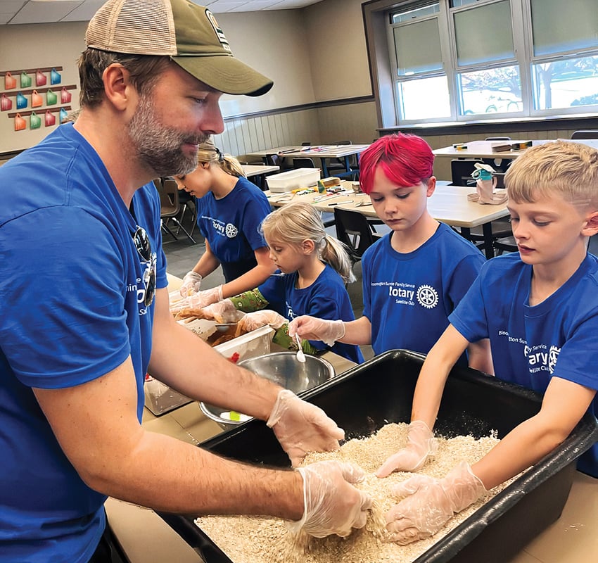 Gabe Gloden takes part in a service project alongside his children.