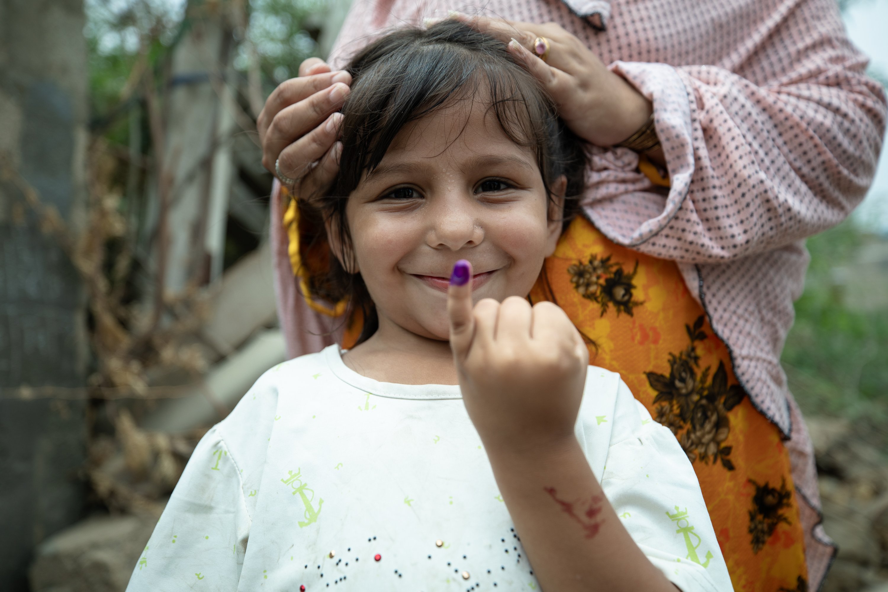 Health workers conduct door-to-door polio vaccinations in a community near Gadap, Pakistan.