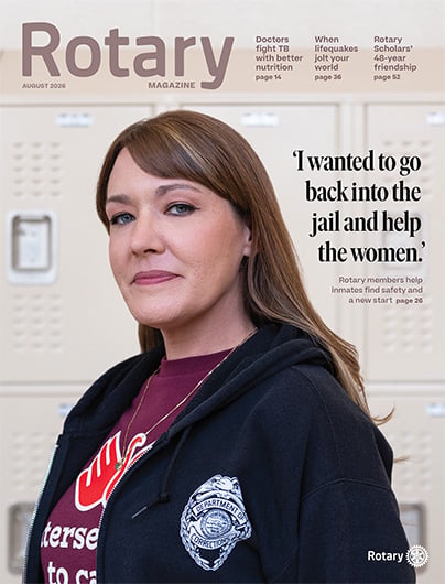 August 2026 Rotary magazine cover - featuring a woman in a hooded sweatshirt, with “Rotary” at the top and the title “I wanted to go back into the jail and help the women.”