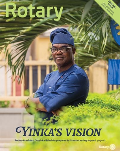 July 2026 Rotary magazine cover - featuring a man in blue traditional attire and cap, with “Rotary” at the top and the title “Yinka’s Vision.”