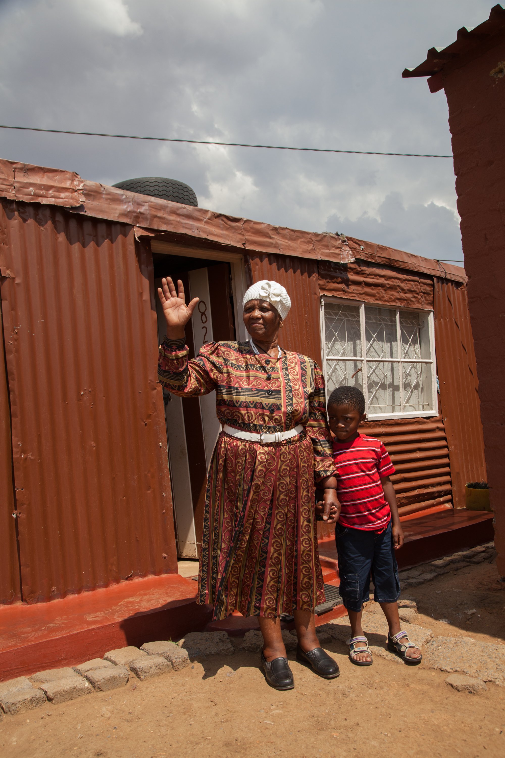 An adult and a child stand together outdoors in Vereeniging, South Africa, during a Rotary Family Health Days campaign that provides free health services and promotes disease prevention on November 11, 2013.