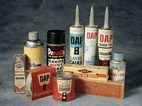 Assortment of vintage DAP putty and caulk products from the early company era