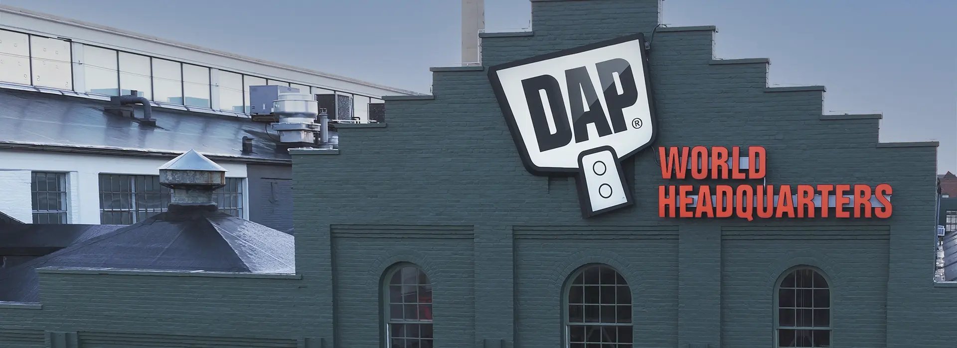 DAP World Headquarters building with large DAP logo signage displayed on the exterior facade.
