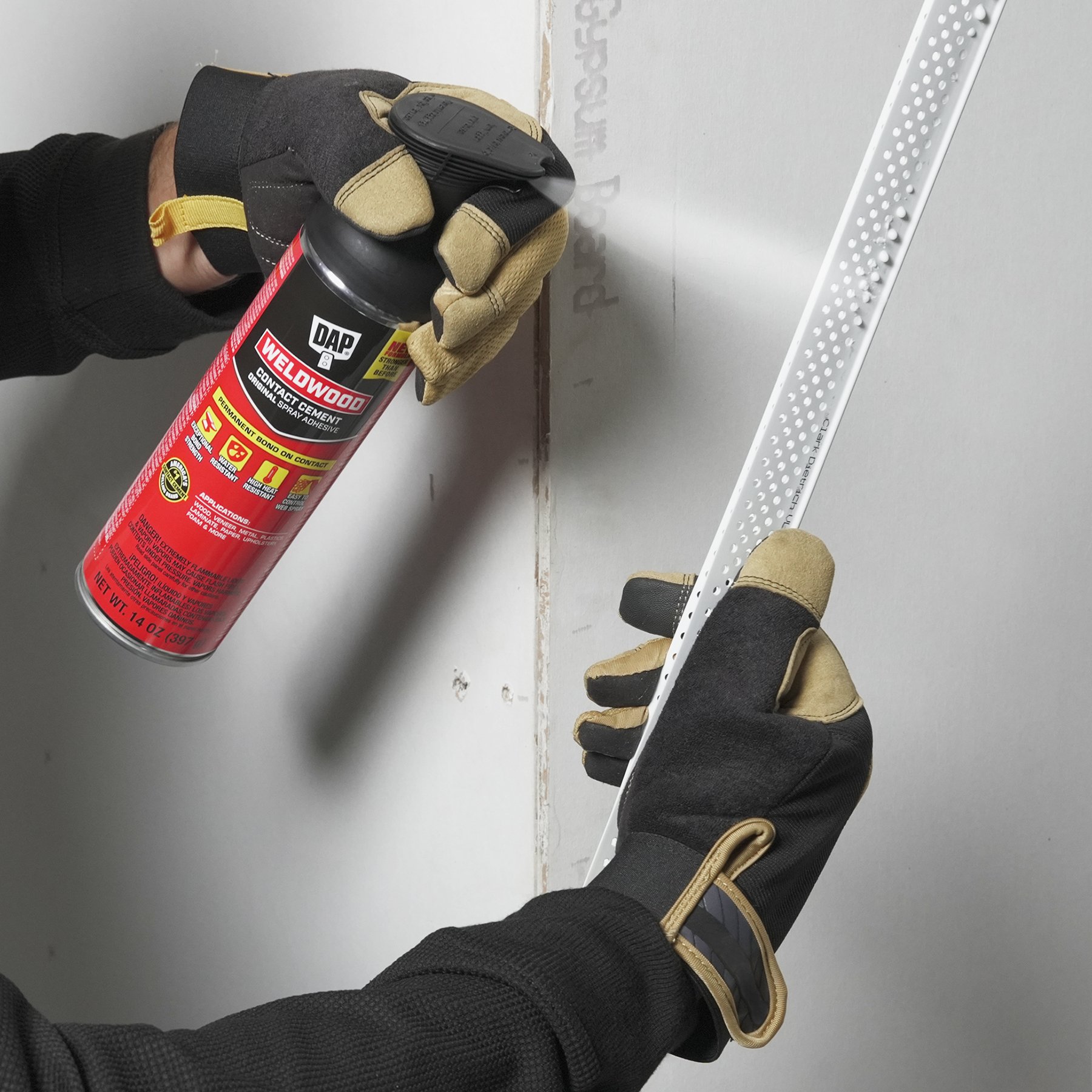 Weldwood Spray Adhesive being applied to cabinet corner plastic