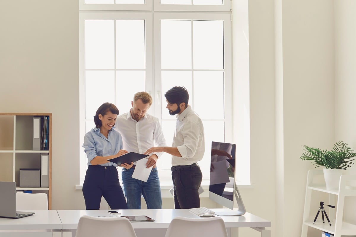 AdobeStock_379064979_Happy company workers meeting talking discussing 1200x800