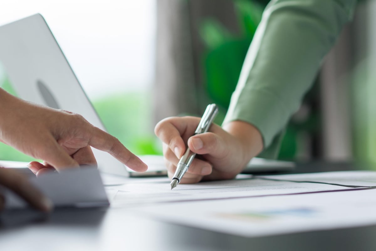 AdobeStock_691257707_Alternative energy environment businesspeople checking document 1200x500