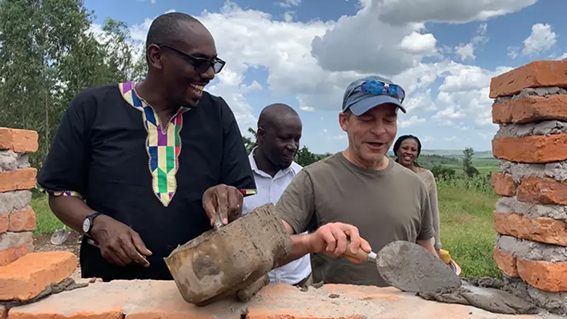 Fisk Johnson helping to build a home in rural Rwanda