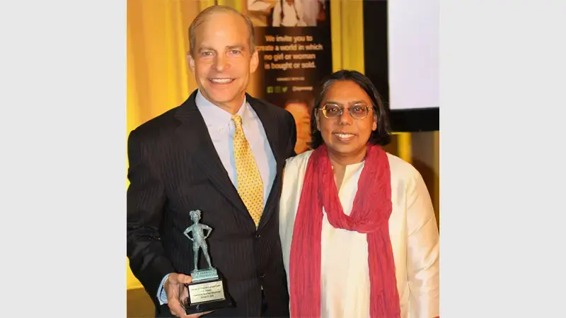 Fisk Johnson receiving “The Last Girl Corporate Inspiration Award” from the anti-sex trafficking group, Apne Aap Women Worldwide (Apne Aap).