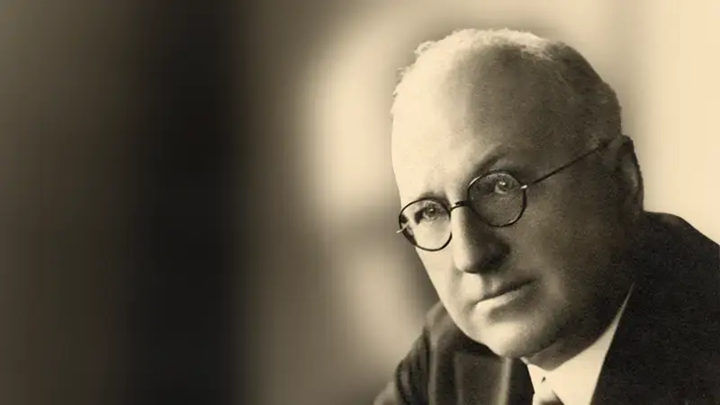 Portrait of Herbert F. Johnson, Sr. sitting at his desk