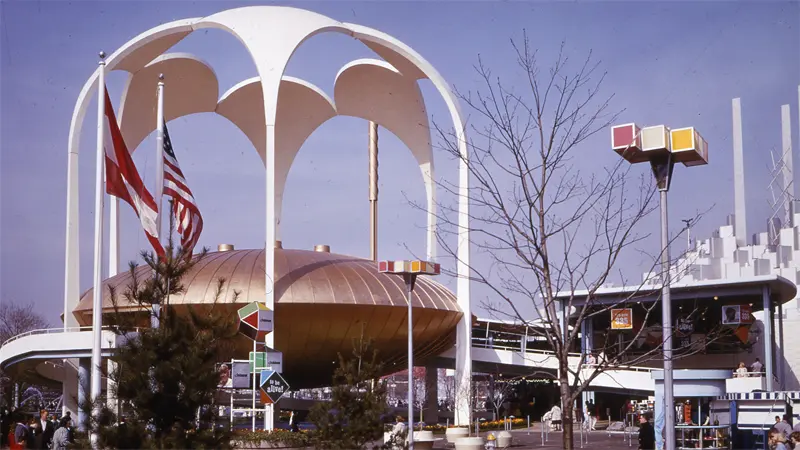 Futuristic pavilion dome showcased at bustling outdoor expo.
