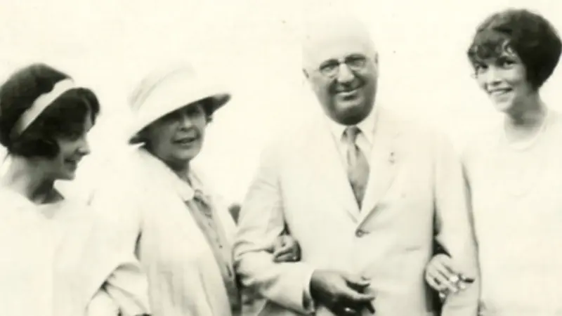 Herbert F. Johnson, Sr. standing in his white suit