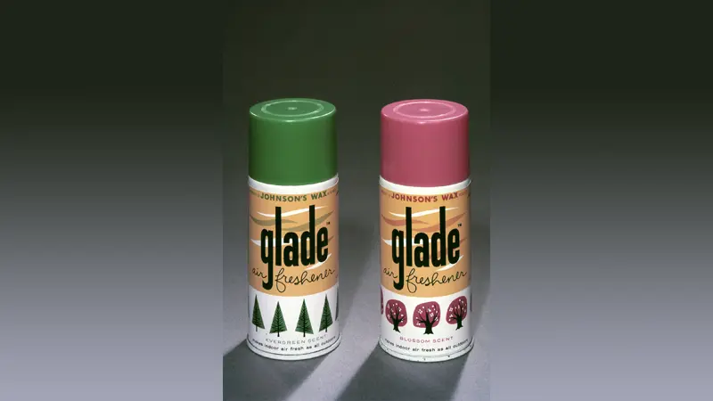 Two Glade air freshener cans; green and pink tops.