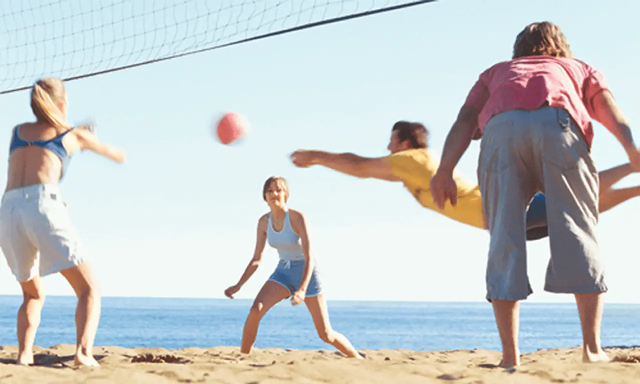 Four people playing beach volleyball