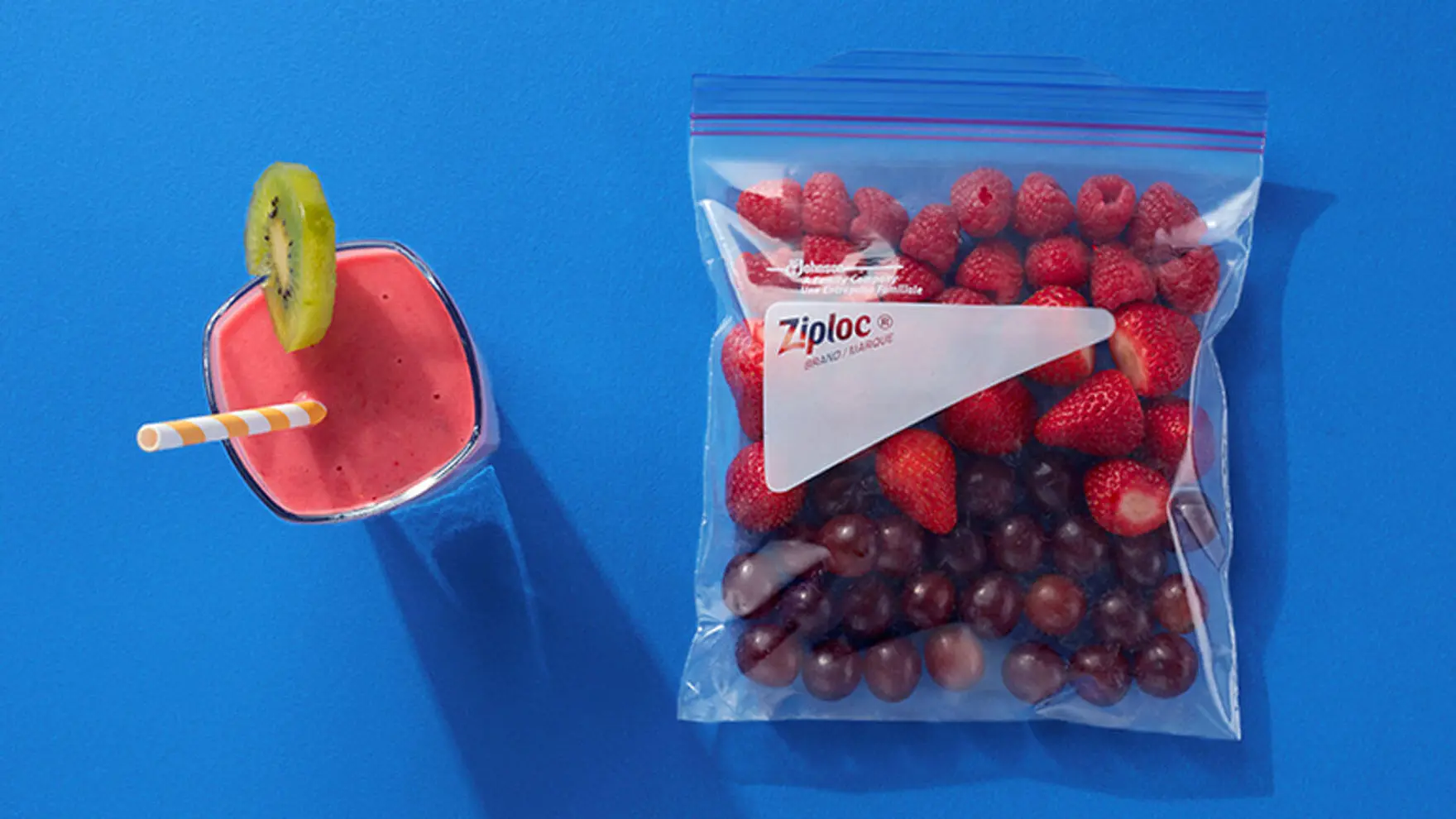 Ziploc bag filled with strawberries, raspberries, and red grapes