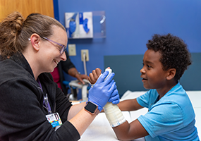 provider applies cast to patient arm