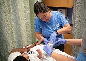 provider applying clubfoot cast to baby