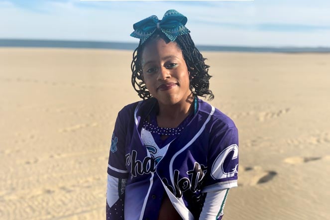 Gabrielle wearing cheer uniform at beach