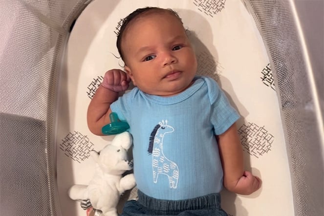 a newborn baby lying in a crib