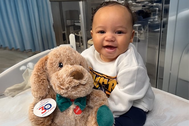 a baby holding a teddy bear