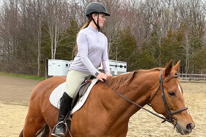 a woman riding a horse