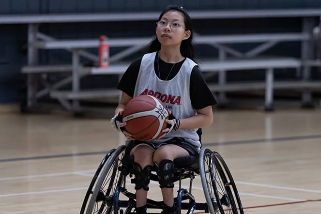 a teenager playing wheelchair basketball